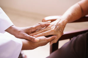 Senior Woman Talking With gerontologist In Hospice
